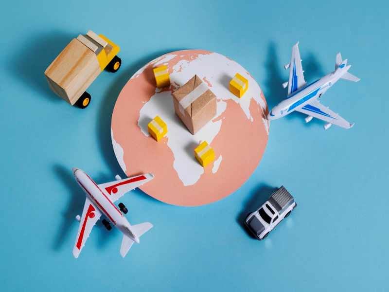 A red shipping container at a bustling terminal with a "Cleared for Transit 2025" banner; a customs official in the foreground uses a tablet to verify the Customs Clearance Completed status.