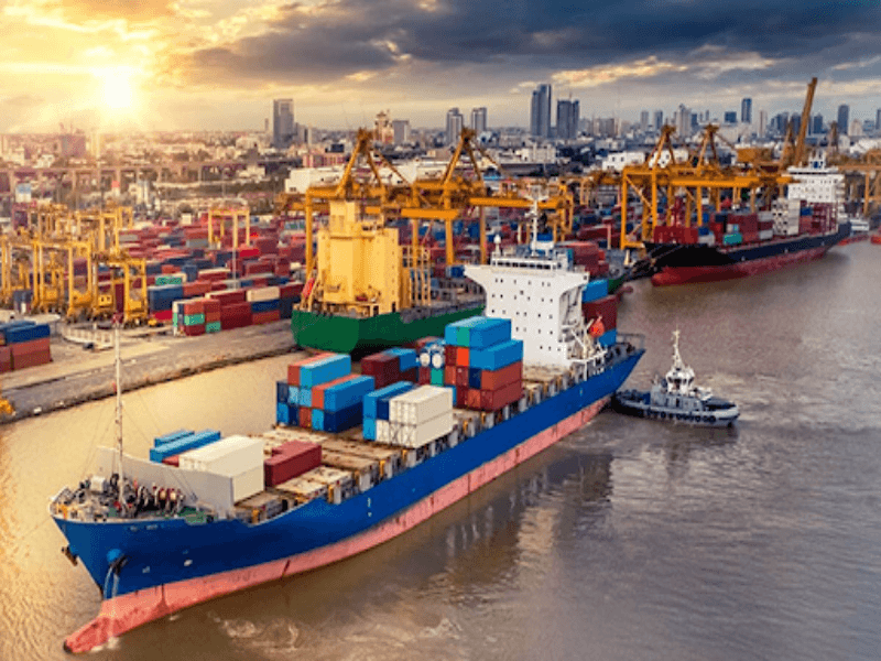Large container vessel at a sunset-lit Indian port representing the push for green shipping and hydrogen-fueled vessels supported by the 2025 Union Budget customs duty exemptions.